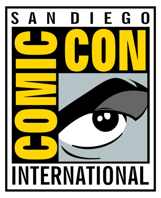 The logo for San Diego Comic-Con International, featuring the words "Comic-Con" in bold yellow letters and a stylized black-and-white eye in the bottom right corner, all within a rectangular frame.