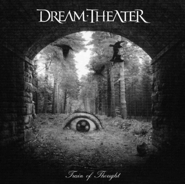 Album cover for "Train of Thought" by Dream Theater (2003), featuring a surreal black-and-white image of a large eye embedded in a forest clearing. The scene is viewed from under a stone archway, with trees surrounding the area. Shadows and misty light add a mysterious and eerie atmosphere.