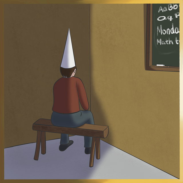 A kid sitting on a wooden bench in a corner, wearing a white dunce cap. The person is facing the wall, and a chalkboard with writing is visible on the adjacent wall.