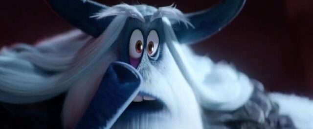 A yeti character from the animated movie "Smallfoot" (2018), with large horns and white fur, wide-eyed, pulling down his right eyelid with his index finger.