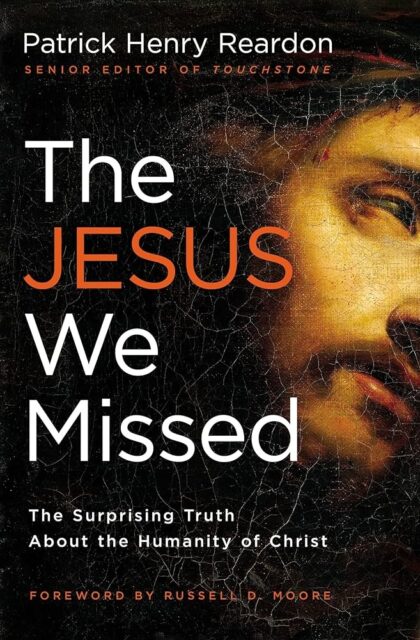 Book cover for "The Jesus We Missed" by Patrick Henry Reardon, featuring a close-up of a partially visible face of Jesus with a cracked, aged texture overlay. The visible eye and part of the face emphasize a contemplative and solemn expression, reflecting the book's exploration of the humanity of Christ. The title and author's name are prominently displayed in bold white and orange letters against a dark background. The tagline on the book cover reads: "The Surprising Truth About the Humanity of Christ."