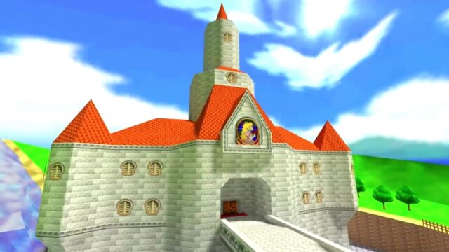 Princess Peach's Castle from the game Super Mario 64. The castle has red-tiled roofs, a tall central tower, and a large entrance bridge. The stained glass window above the entrance features a portrait of Princess Peach. The background includes a bright blue sky with fluffy clouds and green, grassy hills.