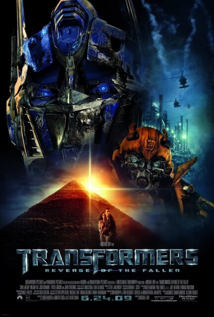 A movie poster for "Transformers: Revenge of the Fallen" featuring large images of Optimus Prime and Bumblebee in the background, with helicopters flying over an industrial landscape. At the bottom, a glowing sun sets behind the top of a pyramid, with two human characters, Sam and Mikaela, standing in front. The movie title is displayed prominently in metallic letters at the bottom.