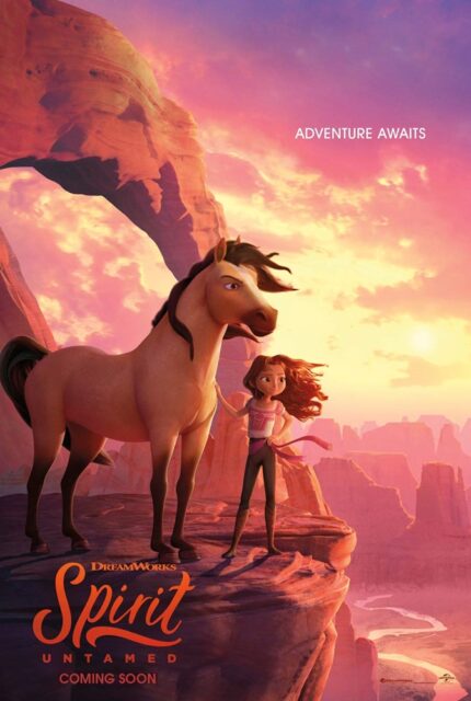 The movie poster for "Spirit Untamed" features a young girl, Lucky Prescott, standing beside a tan horse with a dark mane and tail, named Spirit. They are both positioned on the edge of a rocky mountain cliff, overlooking a vast canyon landscape bathed in warm, pink and orange sunset hues. In the background, a large natural rock arch extends across the sky. Below them, a winding river flows through the canyon, reflecting the soft colors of the sunset. The text "ADVENTURE AWAITS" appears in the upper right corner. At the bottom, the title "DreamWorks Spirit Untamed" is displayed in bold orange letters with the words "COMING SOON" underneath.